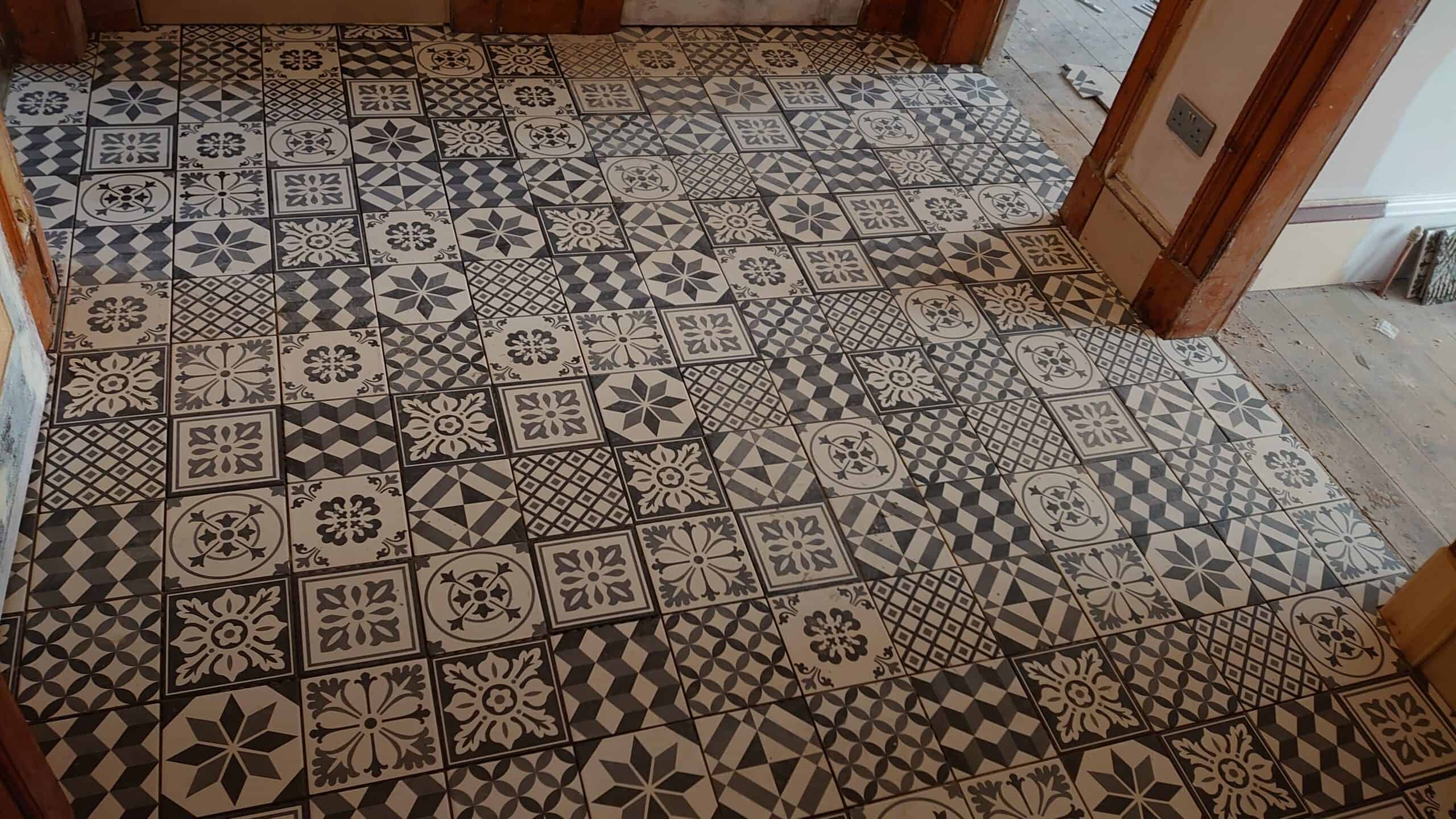 Mosaic hallway floor with intricate patterned tiles by WJ Ceramics.